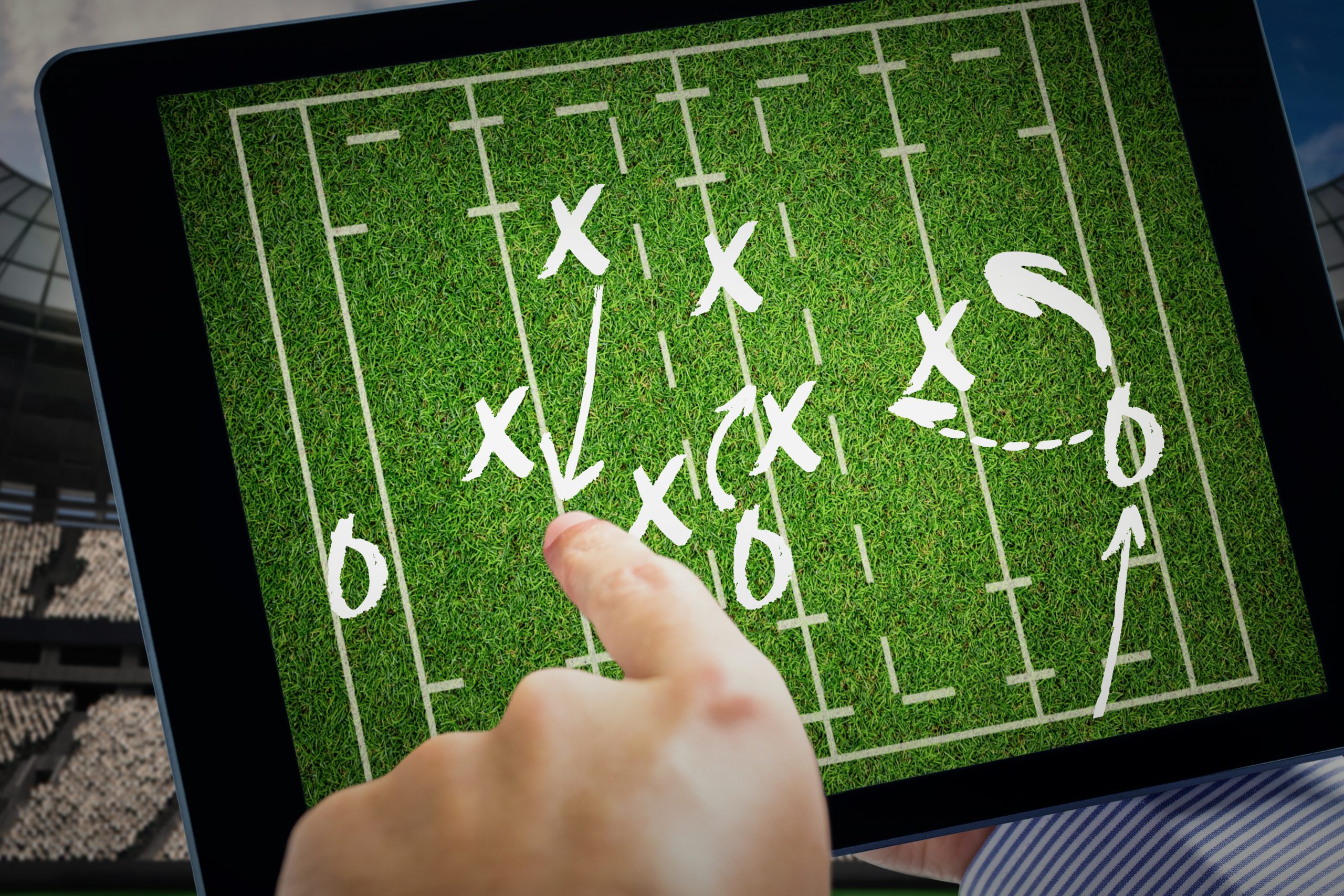 Man using tablet pc against rugby tactics