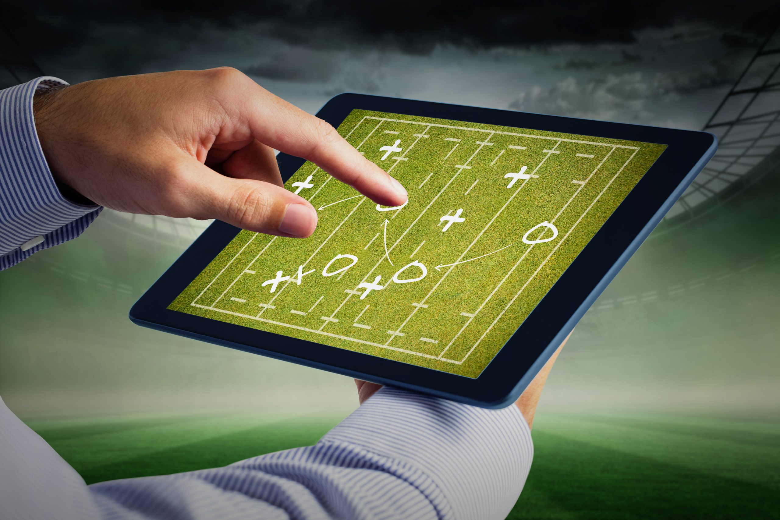 Man using tablet pc against rugby tactics